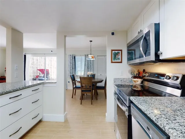 a kitchen with stainless steel appliances granite countertop a stove and cabinets