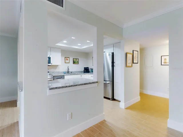 a kitchen with stainless steel appliances granite countertop a refrigerator and a sink