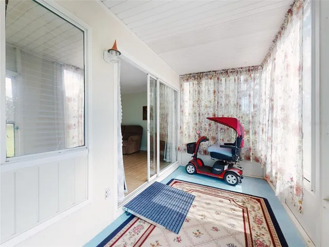 a view of a hallway with wooden floor and closet