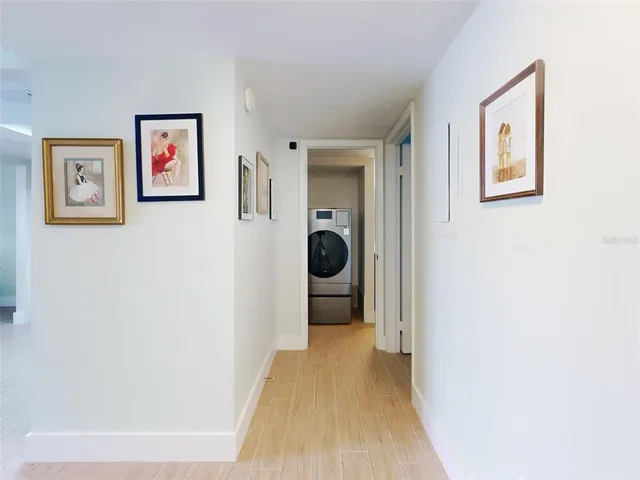 a view of hallway with livingroom and furniture