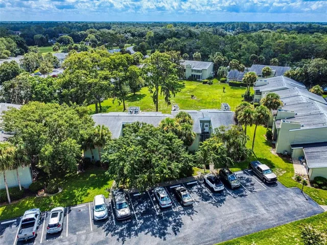 an aerial view of residential house with yard and outdoor seating