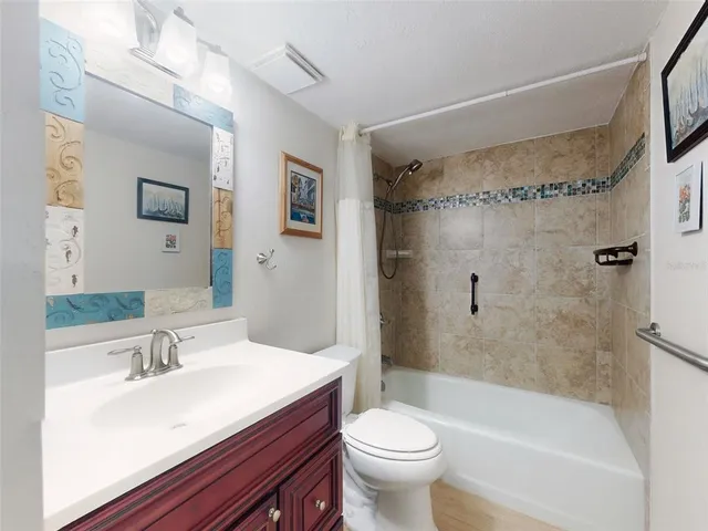 a bathroom with a sink mirror toilet and bathtub