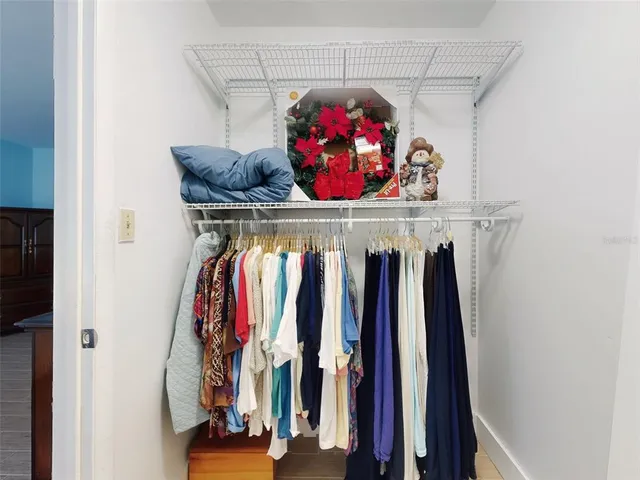 a view of walk in closet with clothes