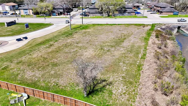 a view of a swimming pool with a yard and sitting area
