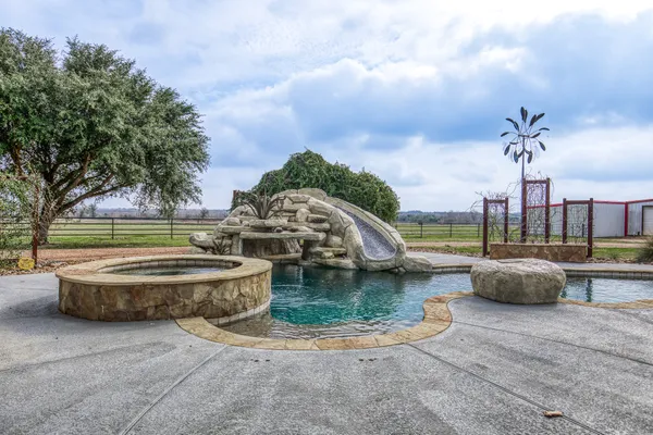 a view of a swimming pool with outdoor seating