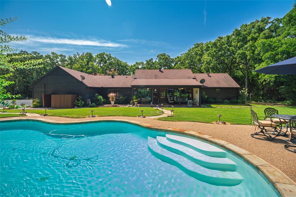 1516 Rancho Road Quinlan, TX 75474 - Photo 30 of 40 a view of an house with swimming pool and yard