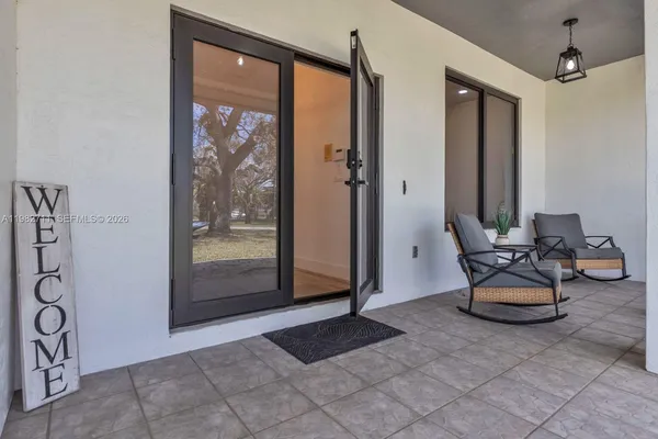 a view of a livingroom with furniture and next to a window