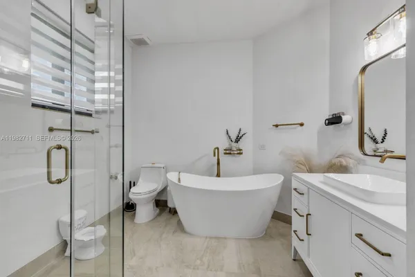 a bathroom with a double vanity sink mirror double and shower