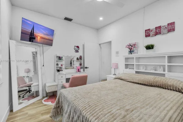 a bedroom with a bed and dresser