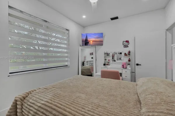 a view of walk in closet with clothes