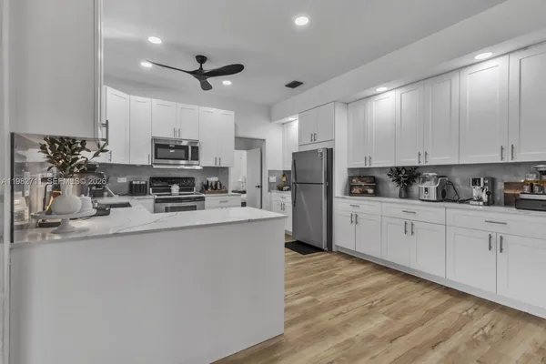 a kitchen with cabinets a sink and appliances