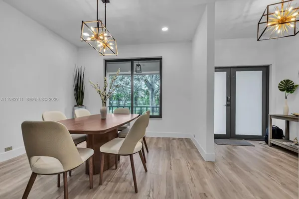 a view of a dining room with furniture wooden floor and chandelier