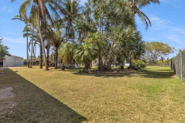 a view of a swimming pool with a house in the background