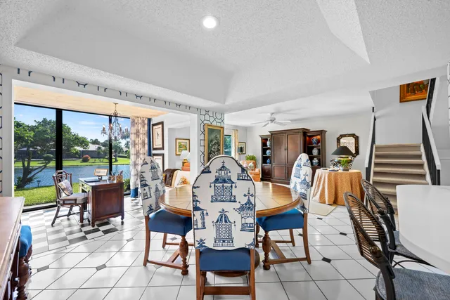 a living room with furniture a fireplace and a floor to ceiling window