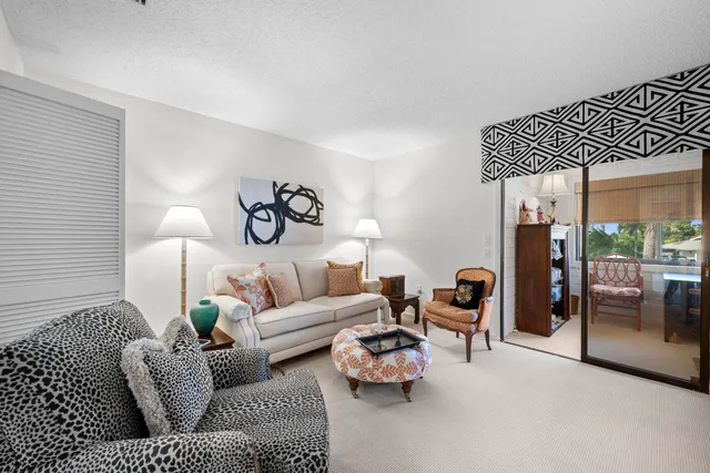 a living room with furniture and a lamp