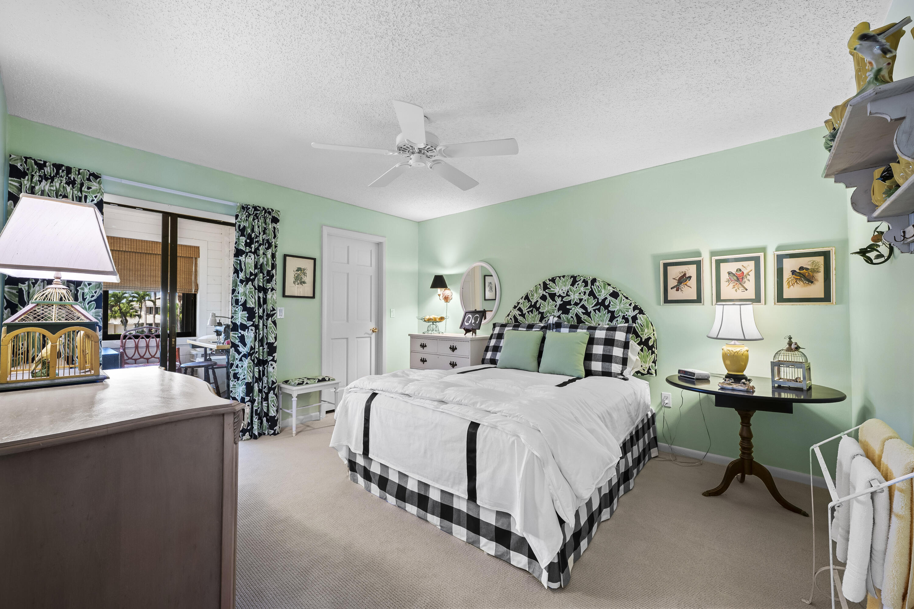 5610 Southeast Foxcross Place Stuart, FL 34997 - Photo 20 of 39 a bedroom with a bed and a table in it