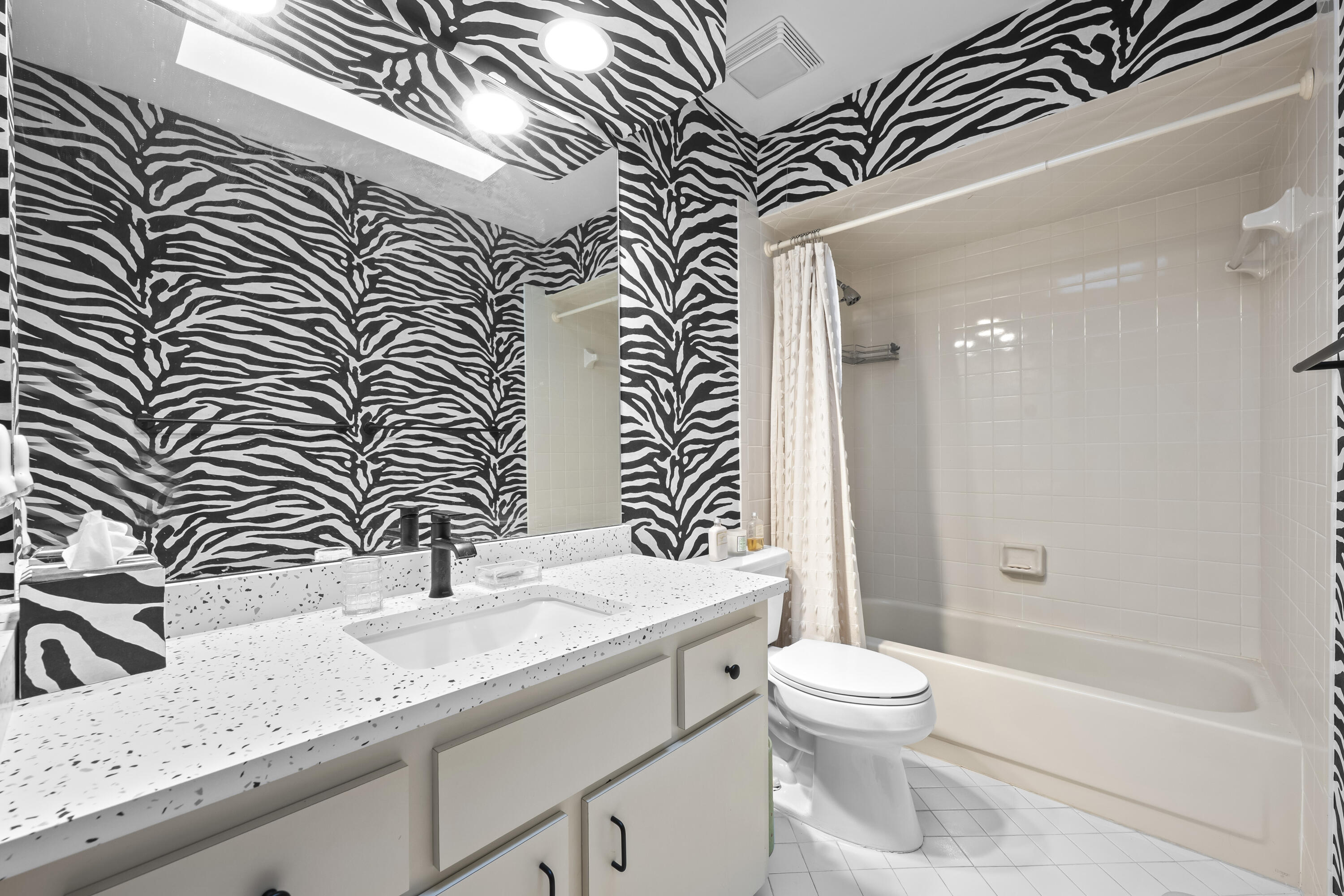 5610 Southeast Foxcross Place Stuart, FL 34997 - Photo 21 of 39 a bathroom with a granite countertop sink a toilet and shower