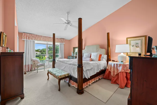 a bedroom with furniture and a large window