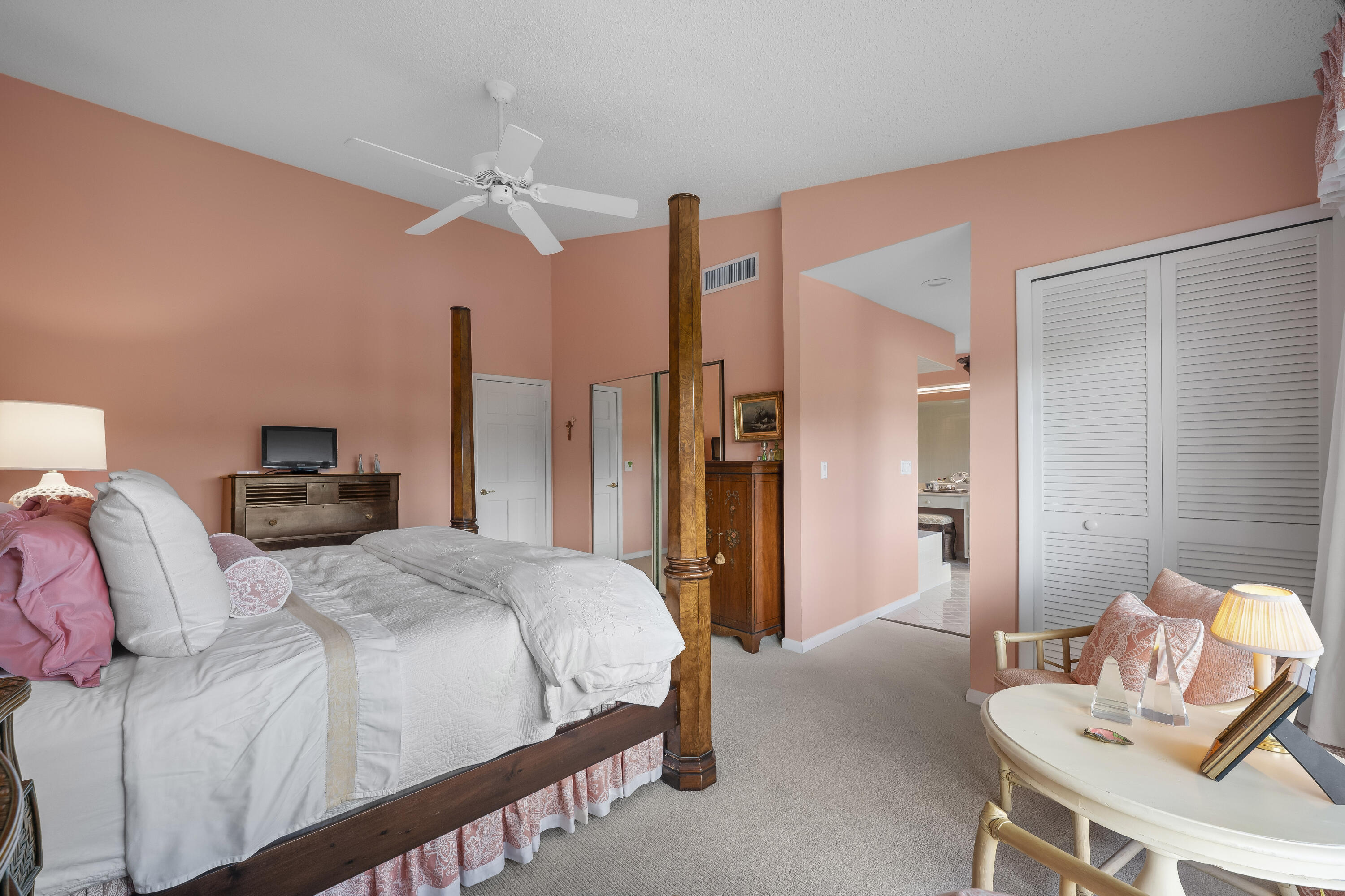 5610 Southeast Foxcross Place Stuart, FL 34997 - Photo 23 of 39 a bedroom with a bed and a chandelier
