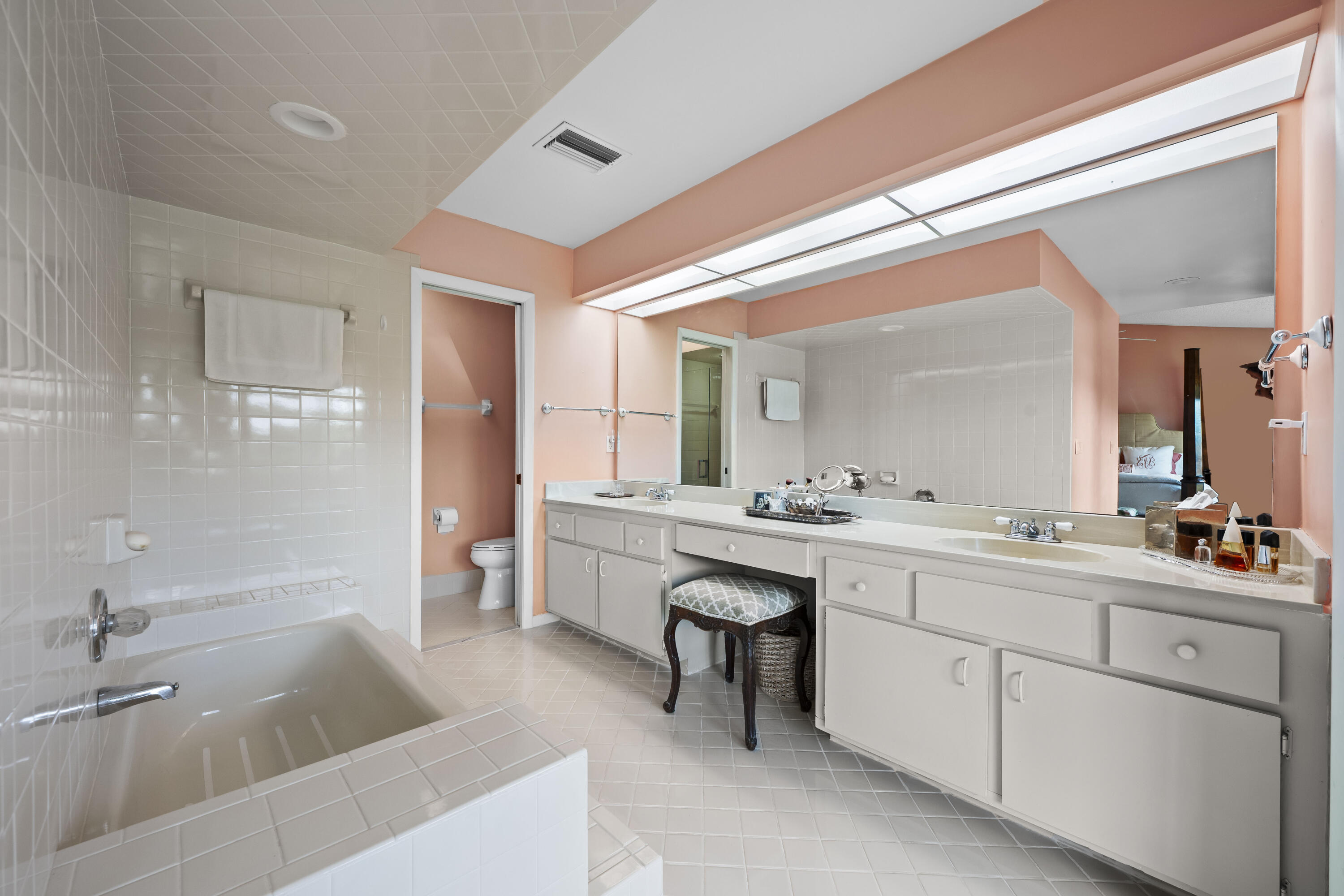 5610 Southeast Foxcross Place Stuart, FL 34997 - Photo 26 of 39 a bathroom with a double vanity sink a toilet a mirror and shower