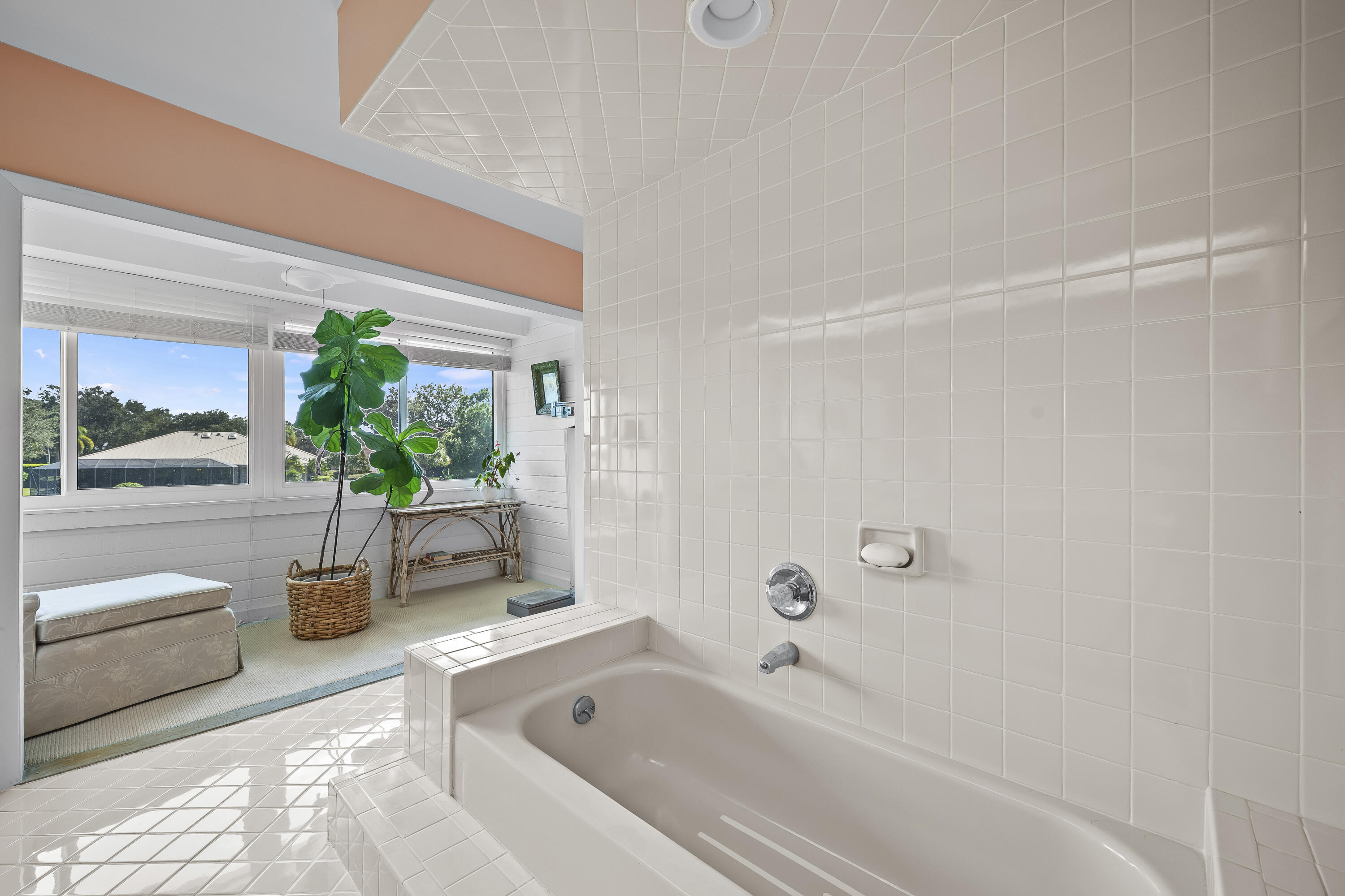 5610 Southeast Foxcross Place Stuart, FL 34997 - Photo 27 of 39 a bathroom with a tub a potted plant and a shower