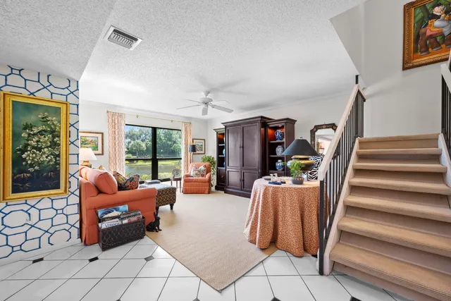 a living room with furniture and a floor to ceiling window