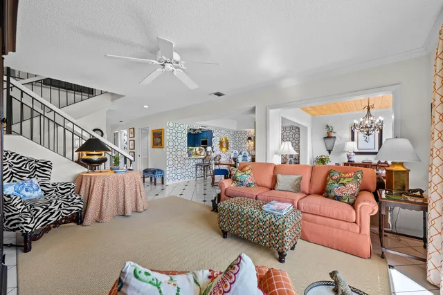 a living room with furniture and stairs