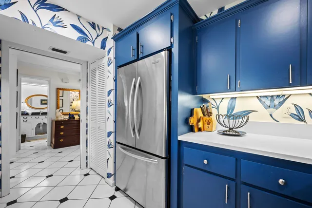 a kitchen with stainless steel appliances granite countertop a refrigerator a stove and a sink