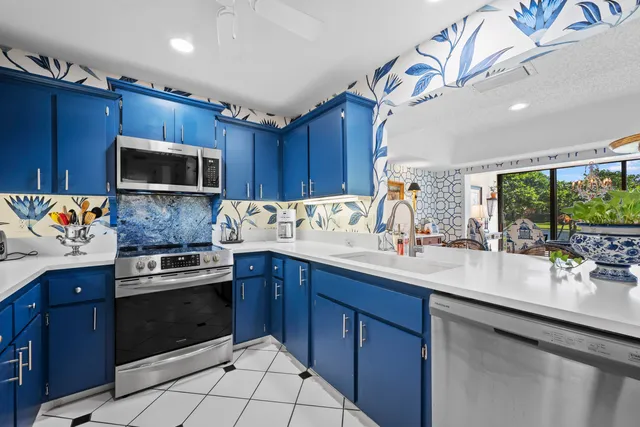 a kitchen with a sink stove and microwave