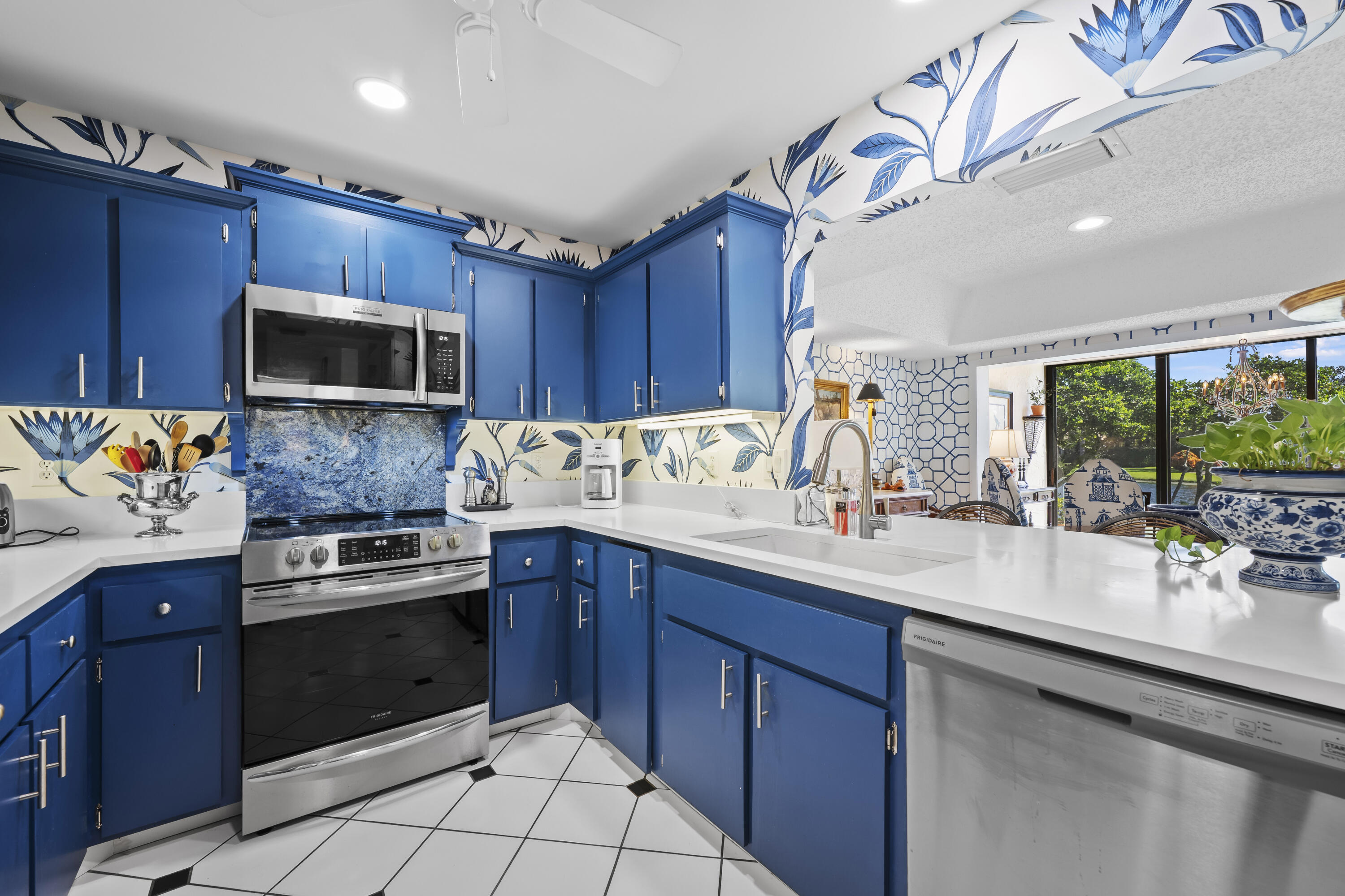 5610 Southeast Foxcross Place Stuart, FL 34997 - Photo 9 of 39 a kitchen with a sink stove and microwave