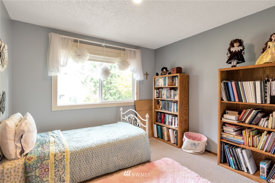 2603 177th Street Southeast Bothell, WA 98012 - Photo 15 of 25 a bedroom with a bed and a book shelf