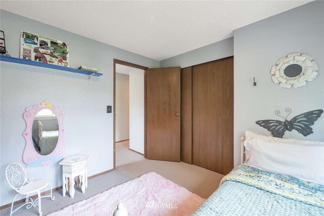 2603 177th Street Southeast Bothell, WA 98012 - Photo 16 of 25 a bedroom with a bed and a chair
