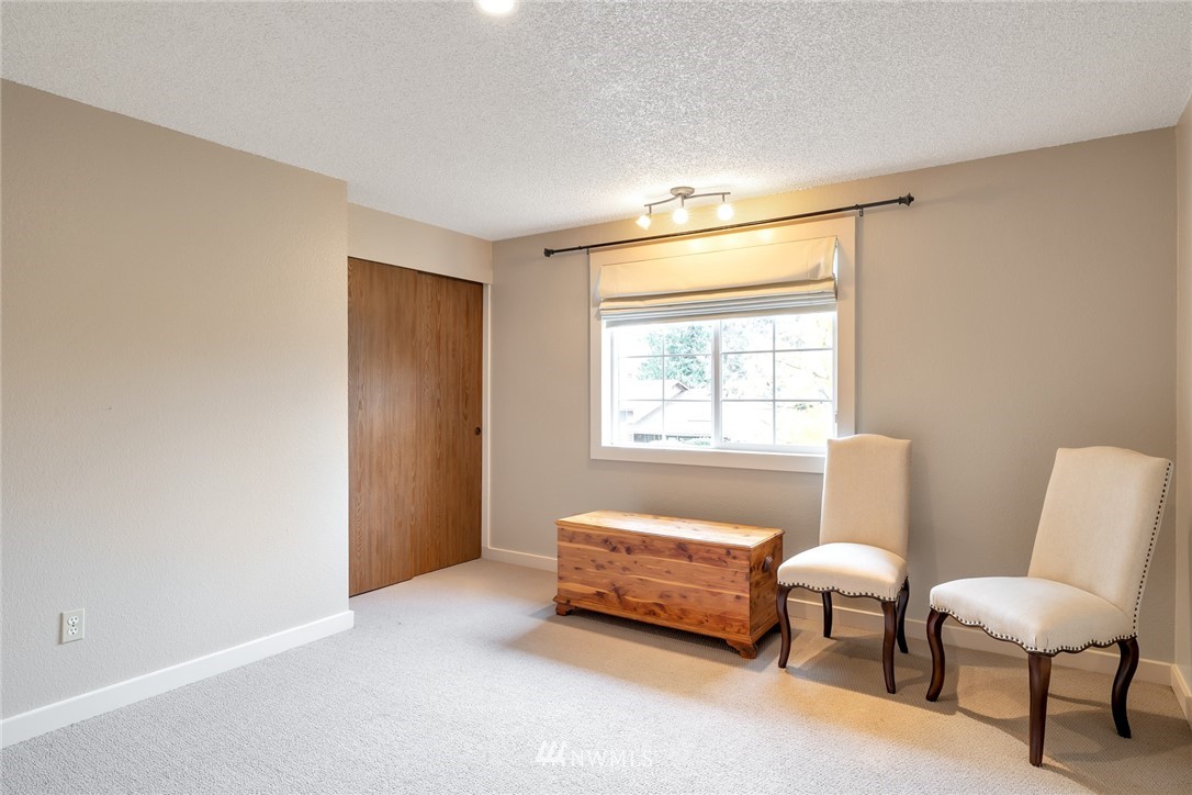 2603 177th Street Southeast Bothell, WA 98012 - Photo 18 of 25 a bedroom with a bed and a chair