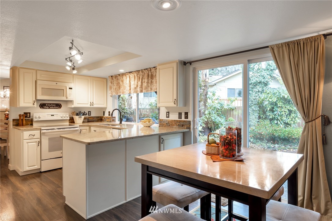 2603 177th Street Southeast Bothell, WA 98012 - Photo 4 of 25 a kitchen with a table chairs sink and cabinets