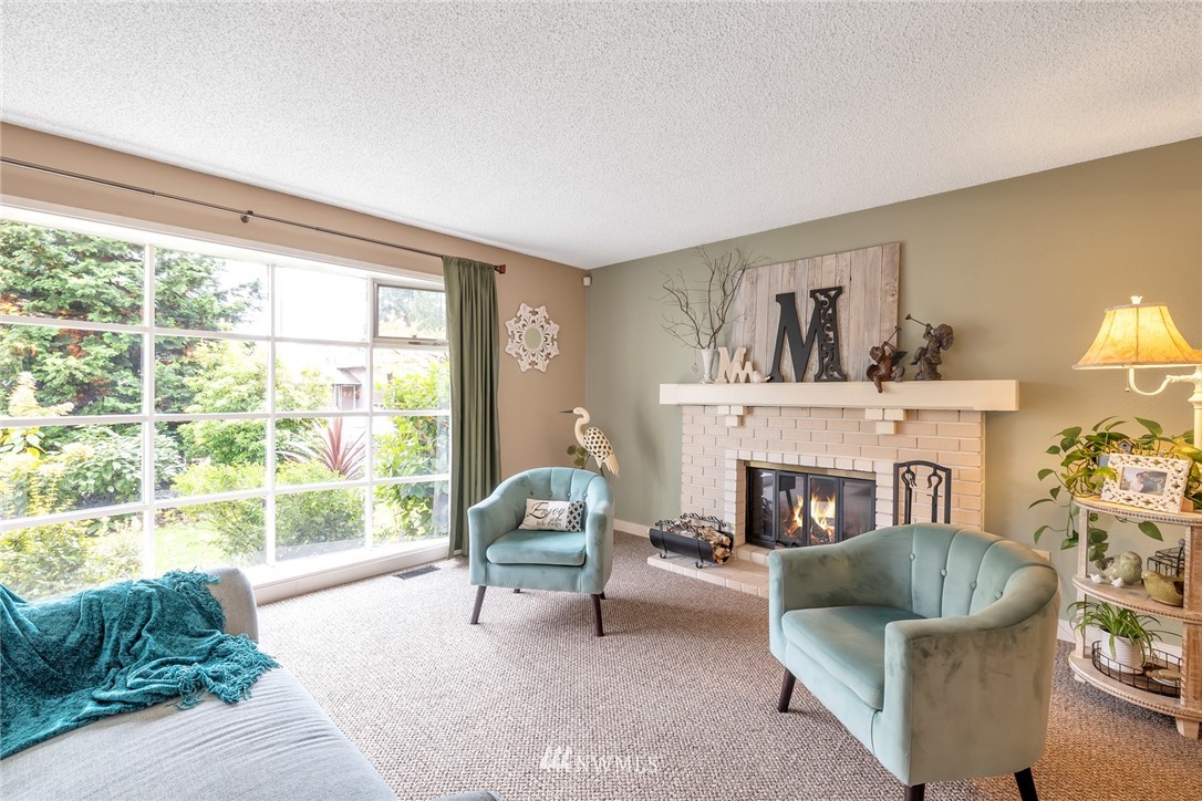 2603 177th Street Southeast Bothell, WA 98012 - Photo 8 of 25 a living room with furniture and a fireplace