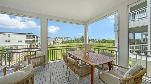 a view of a balcony with wooden floor and outdoor seating