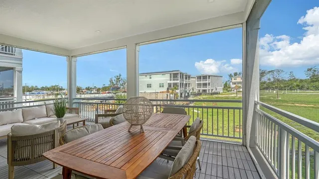a view of a balcony dining table and chairs with wooden floor