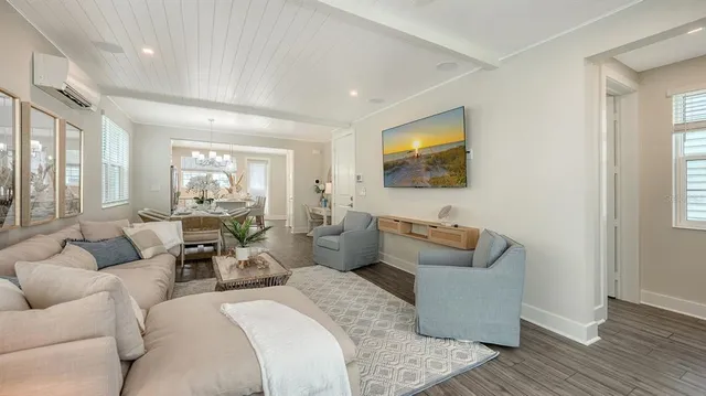 a bedroom with furniture and a large window