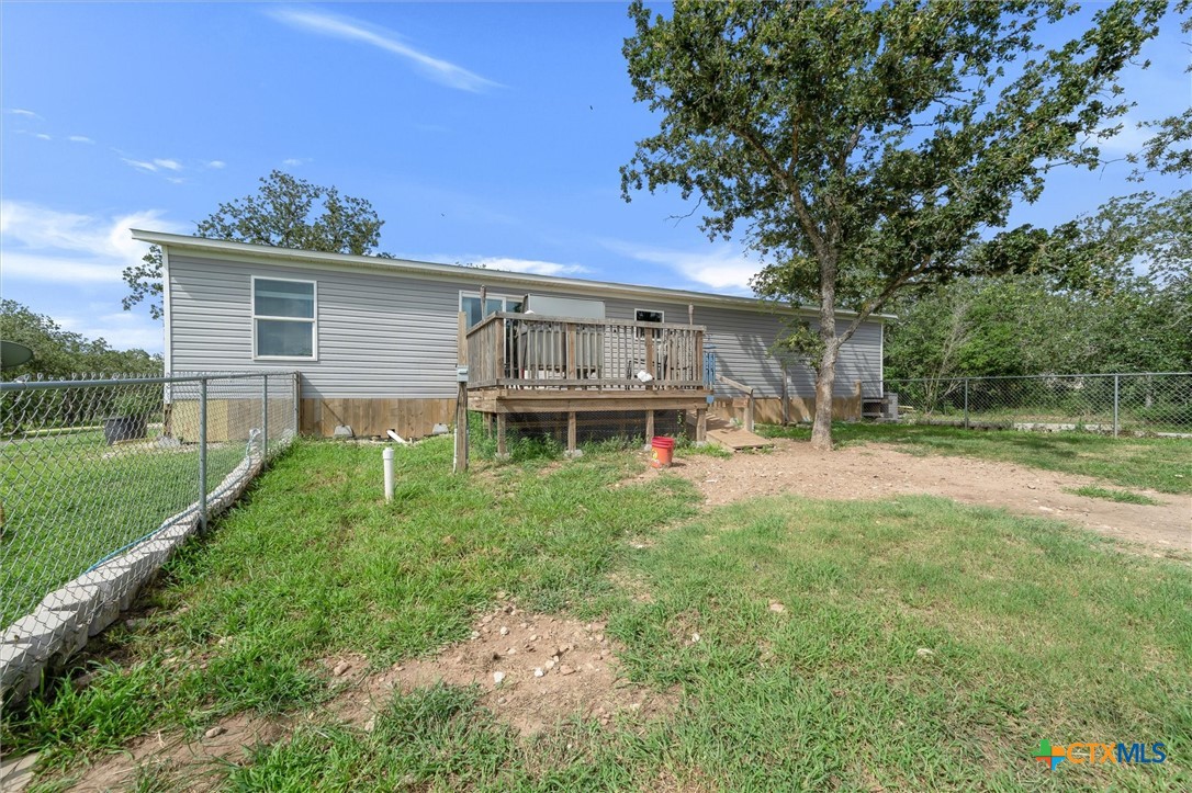 2755 Washburn Road Luling, TX 78648 - Photo 24 of 40 Back of House #1, featuring a back deck and a chain linked fence.