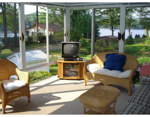 72 South Shore Road Westhampton, MA 01027 - Photo 3 of 10 a outdoor living space with furniture a flat screen tv and a floor to ceiling window