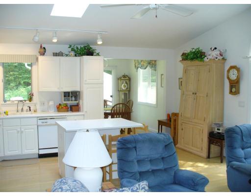 72 South Shore Road Westhampton, MA 01027 - Photo 5 of 10 a living room with kitchen island furniture and a fireplace