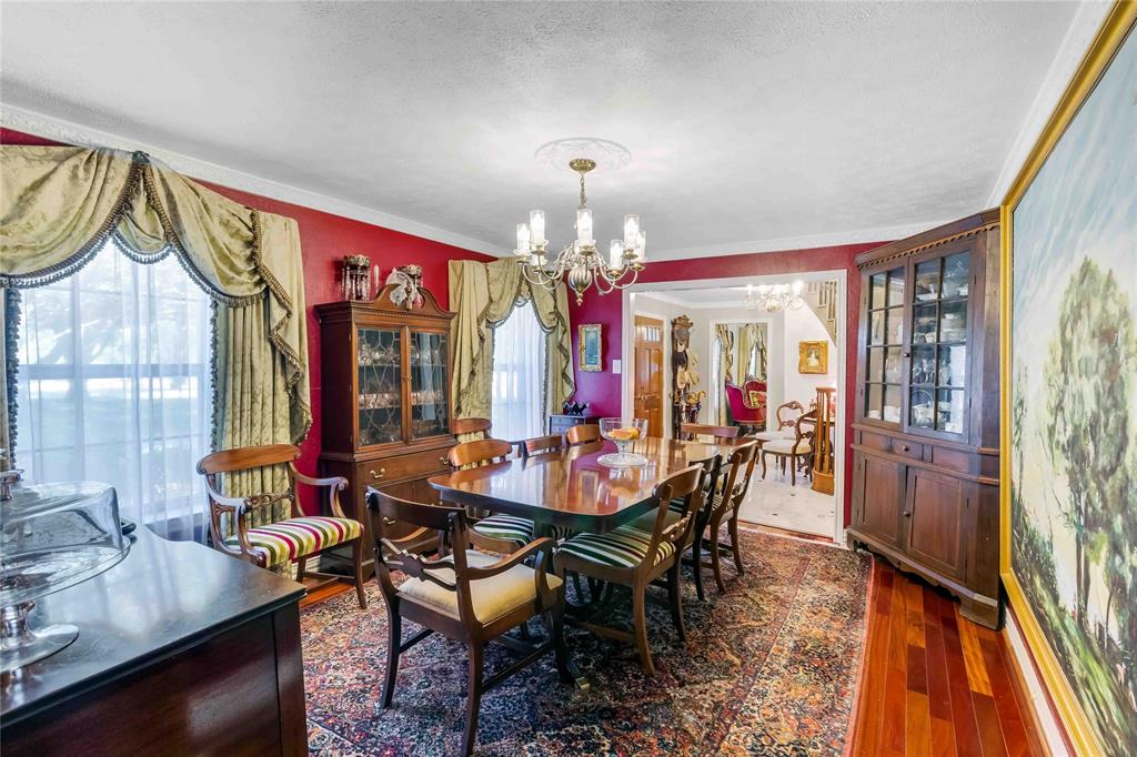 216 McMillen Road Lucas, TX 75002 - Photo 7 of 36 a view of a dining room with furniture wooden floor and chandelier