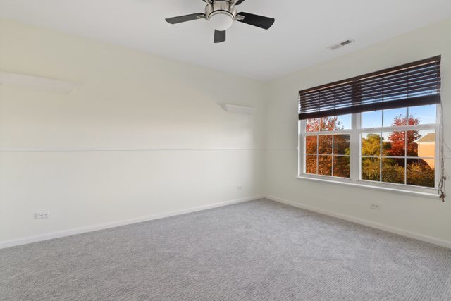 770 Lambert Lane, Unit 966 Bartlett, IL 60103 - Photo 23 of 33 a view of an empty room with a window