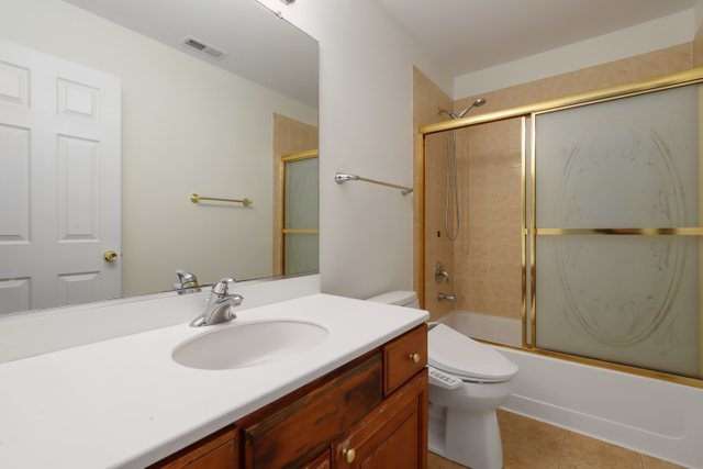 770 Lambert Lane, Unit 966 Bartlett, IL 60103 - Photo 25 of 33 a bathroom with a sink toilet and shower