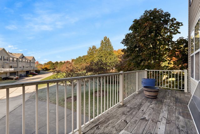770 Lambert Lane, Unit 966 Bartlett, IL 60103 - Photo 30 of 33 a view of a balcony with wooden floor and fence