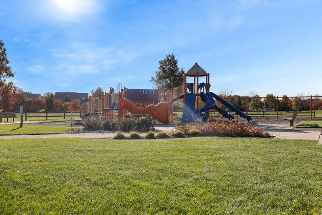 770 Lambert Lane, Unit 966 Bartlett, IL 60103 - Photo 32 of 33 a view of a playground with a house in the background