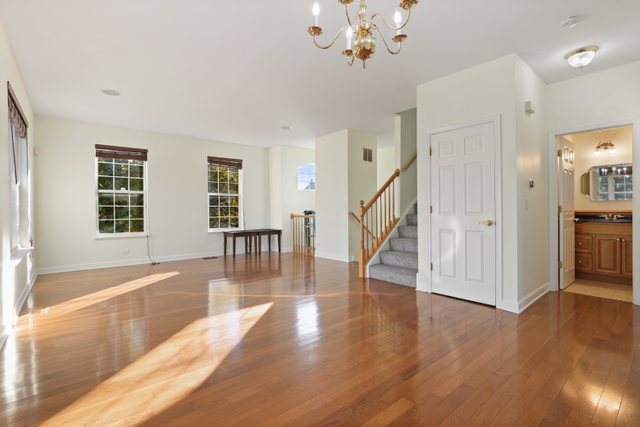 770 Lambert Lane, Unit 966 Bartlett, IL 60103 - Photo 5 of 33 a view of an room with wooden floor and staircase