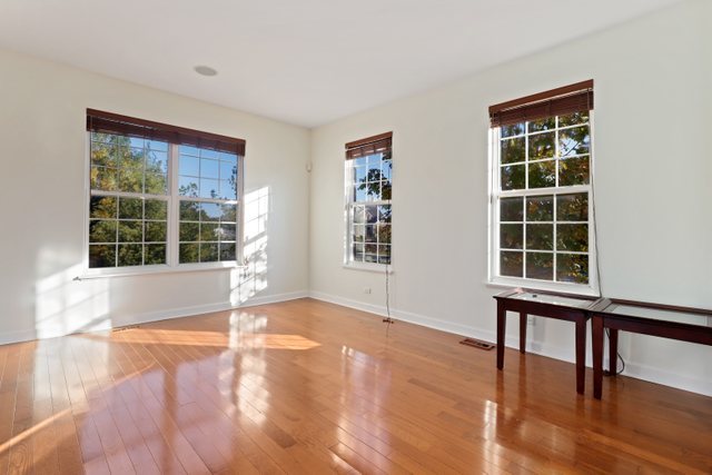 770 Lambert Lane, Unit 966 Bartlett, IL 60103 - Photo 6 of 33 a view of an empty room with a window and wooden floor