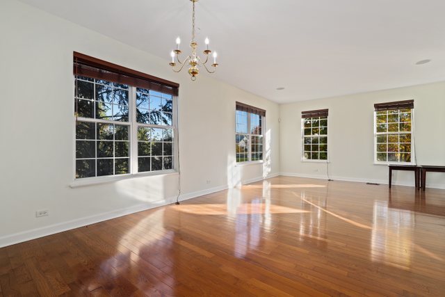 770 Lambert Lane, Unit 966 Bartlett, IL 60103 - Photo 7 of 33 a view of an empty room with wooden floor and a window