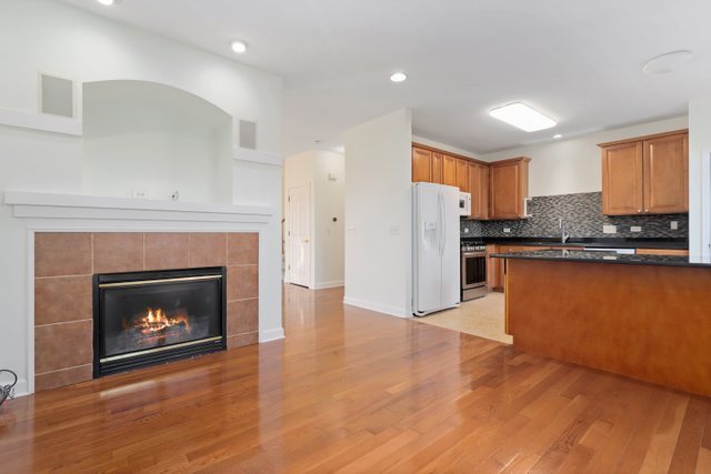 770 Lambert Lane, Unit 966 Bartlett, IL 60103 - Photo 10 of 33 a view of a kitchen with a sink a fireplace and a window